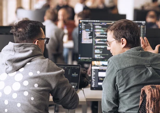 Two developers working at a shared desk